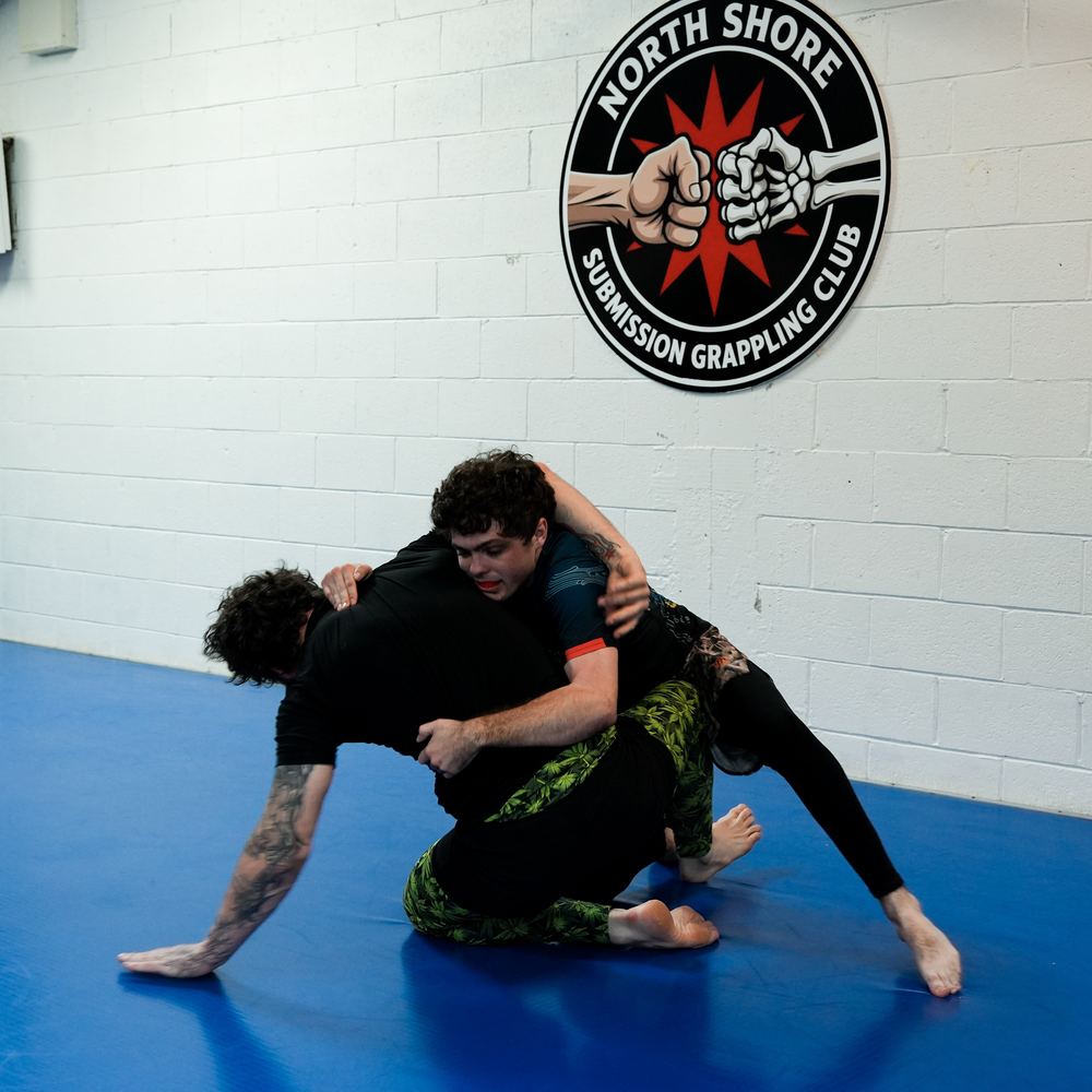 Experienced grapplers sparring in an Advanced class